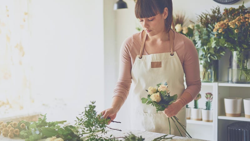 Woman arranging flowers for a bouquet